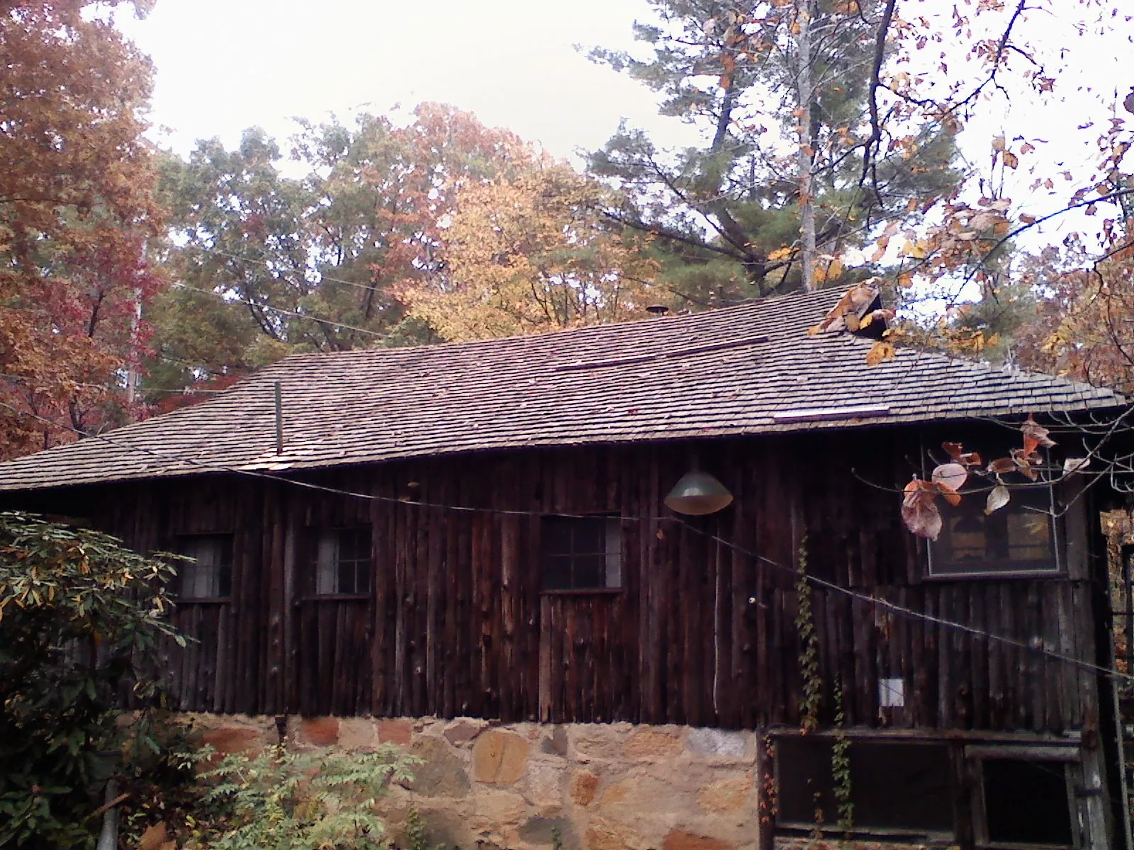 Weathered wood shake roof on a rustic board sided cabin in Bonne Terre